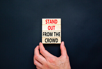 Stand out from the crowd symbol. Concept words Stand out from the crowd on wooden blocks on...