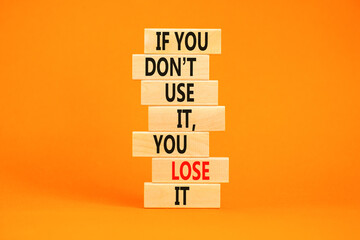 Use or lose symbol. Concept words If you do not use it you lose it on wooden blocks on a beautiful...