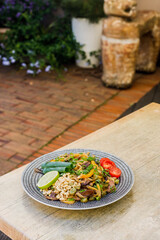 asian stir fried noodles with beef peppers and onions panorama