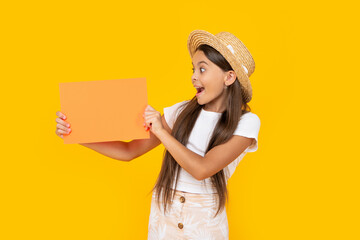 amazed teen girl with copy space on orange paper on yellow background