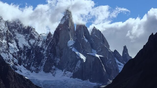 El Chalten, Argentina: Time lapse of clouds moving around the stunning Cerro Torre Peak near the Fitz Roy in the Los Glaciares National Park in El Chalten in Argentinian Patagonia  with a zoom out.