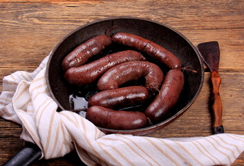 Whole blood sausages on a metal pan,Traditional latvian blood sausages