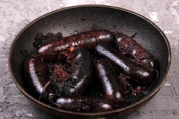 Whole blood sausages on a metal pan,Traditional latvian blood sausages - obrazy, fototapety, plakaty