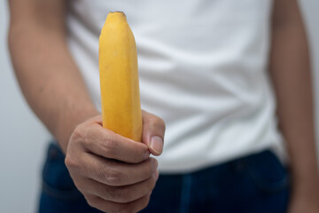 Man holding a banana (penis concept)