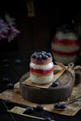 Chia pudding with berries on the wooden background.