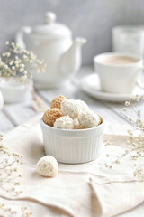 white and beige candies lie in a plate on a white background
