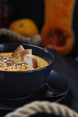 Pumpkin soup with orange juice, croutons and seeds