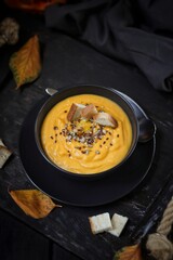 Pumpkin soup with orange juice, croutons and seeds