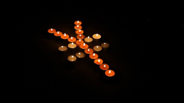 Japanese Yen Symbol Made of Burning Votive Candles Black Back Ground