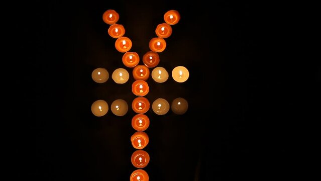 Japanese Yen Symbol Made of Burning Votive Candles Black Back Ground