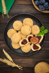 Plum dumplings with brown suggar on the wooden table