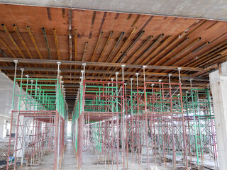 JOHOR, MALAYSIA -JUNE 6, 2022: Metal scaffolding is used as a temporary structure that supports works at the construction site. Also used as a structure for working at height outside the building.
