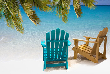 Two beach chairs on white sand Caribbean coast
