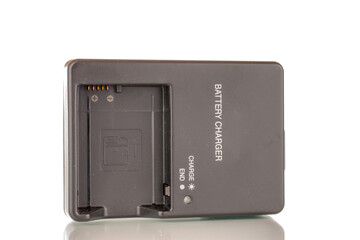 One charger for the camera, close-up, isolated on a white background.