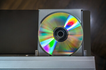 close-up vintage cd player with cd. DVD inserting to video player.
