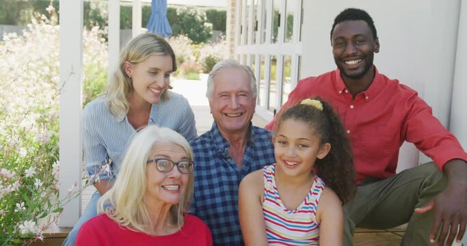 Video of diverse family spending time together outside