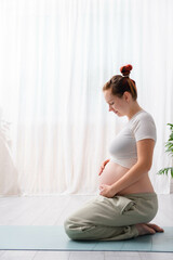 Portrait beautiful young pregnant woman with big belly, training sport, doing yoga, practicing...