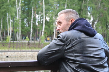 Fototapeta premium a mature man was thinking while in the park in the spring