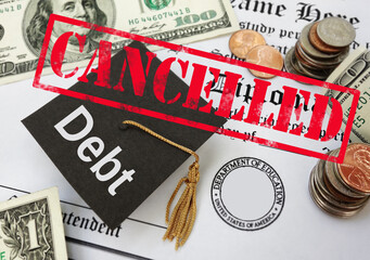 Cancelled stamp over student loan debt graduation cap and money - 530109073
