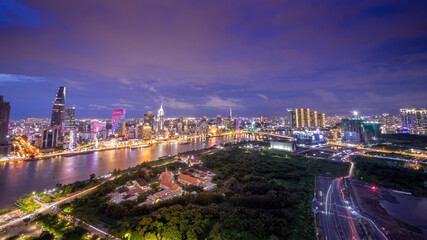 Aerial view view of Ho Chi Minh City skyline and the Saigon River at sunset. Amazing colorful view of skyscraper and other modern buildings at downtown.