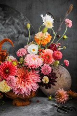 Big beautiful bouquet. Flower arrangement on a beige background. A wide variety of farm flowers. English floristry. Dahlias, zinnias, moluchella and scabiosa.