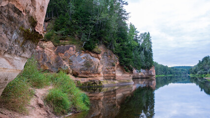 Scenic landscape of the Gauja river. Sandy stones on the shore. Summer nature in Latvia. Gaujas national park