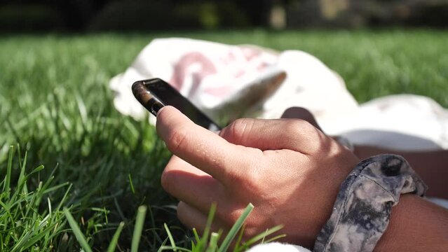 Sexy young woman sunbathing and looking at her smartphone in the grass area of the swimming pool, Sant Cugat del Valles, Catalonia, Spain.
Static camera movement, mid angle, 4K.