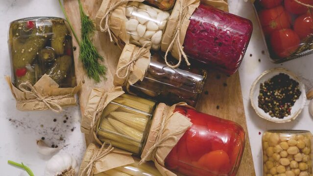 Cucumber, pepper, tomatoes, mushrooms pickling and canning into glass jars. Ingredients for vegetables preserving
