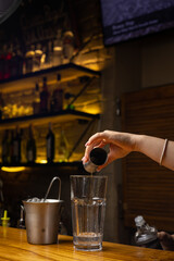 A bartender prepares a cocktail at the restaurant bar
