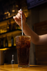 A bartender prepares a cocktail at the restaurant bar
