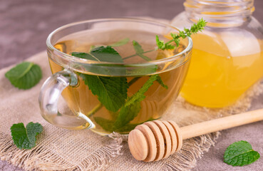Mint tea with honey in a transparent cup.Close-up.	