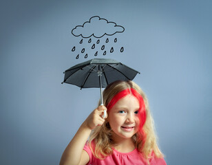 Cute little girl standing under umbrella and smiling.Collage with doodle rain cloud. Kids mental...