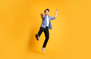 Fototapeta na wymiar full body image of asian man posing on yellow background