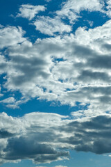 Blue sky with thunderclouds. The sun breaks through the clouds. Black clouds.