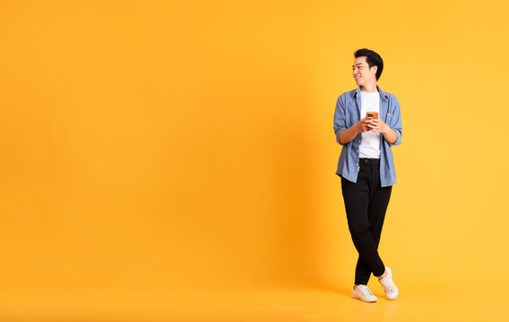 Full Body Image Of Asian Man Posing On Yellow Background