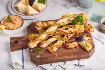 Bread sticks grissini with parmesan cheese and spinach filling. Savory snack. Delicious homemade appetizer.