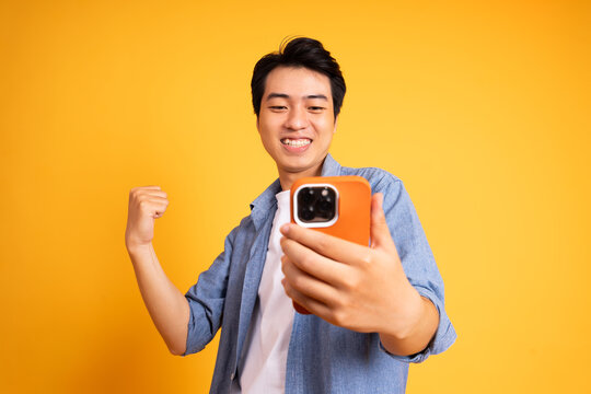image of asian man posing on a yellow background