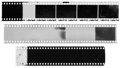 Old, used, dusty and scratched celluloid film strips on transparent background - 530124899