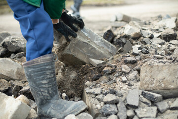 Worker sorts through wreckage of house. Construction details.