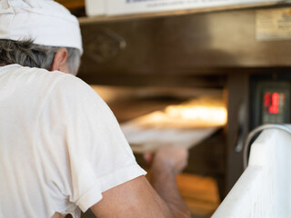 Bakers bake traditional roman pizza early in the morning, traditional bakery