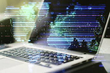 Double exposure of abstract digital world map on laptop background, research and strategy concept