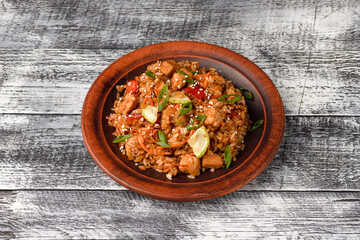 Pilaf with meat, vegetables, chicken. homemade pilaf on a white wooden background