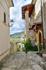Fototapeta na wymiar A narrow street between the old stone houses of Caramanico Terme, a medieval village in the Abruzzo region of Italy.