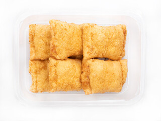 Sweet baked goods in a plastic container, box, isolated, top view. Baked cakes, a packshot photo for package design.