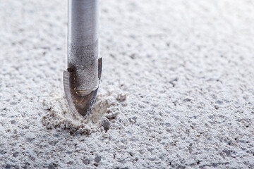 Ceramic drill bit make holes in concrete wall with industrial drill. Building work industry.