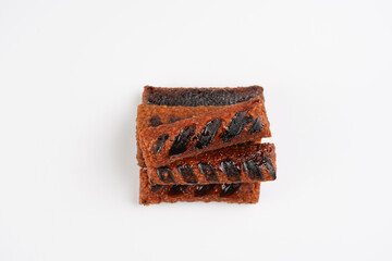 Traditional south european skinless sausages cevapcici made of ground meat and spices, vegan substitute made of soy protein, stacked on white background, top view
