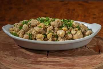 Portion of manioc farofa with eggs, typical Brazilian dish called farofa de ovos