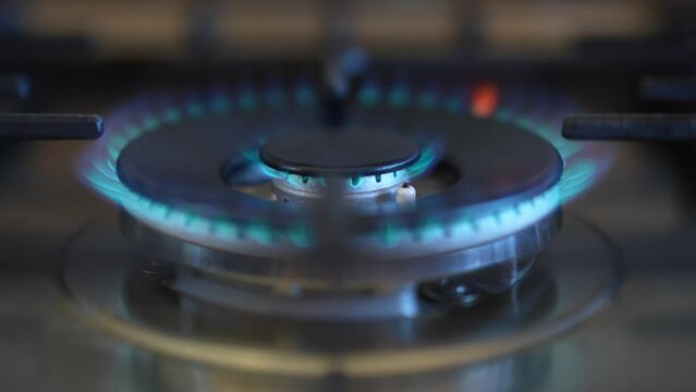 Closeup of turning on the gas stove to cook.