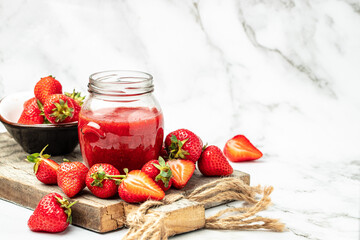 Jar of strawberry jam . Homemade strawberry marmelade and fruits on wooden board. Long banner format
