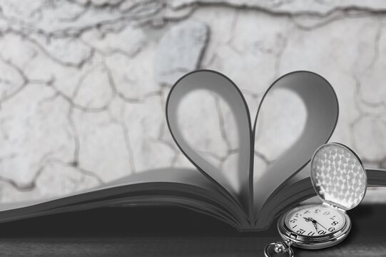 Vintage pocket watch and book with heart shape